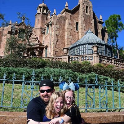A family photo outside the Haunted Mansion